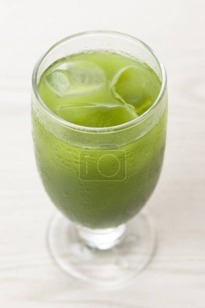 Photo for Close-up view of glass of iced matcha green tea on light background - Royalty Free Image