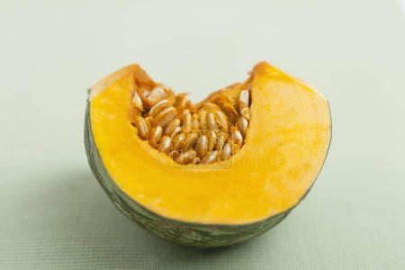 Photo for Close up of pumpkin piece on table, autumn food - Royalty Free Image