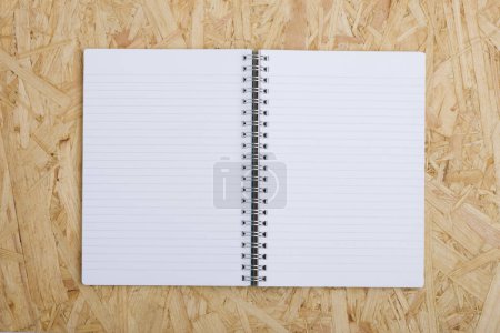 Photo for Blank notepad on the wooden background. - Royalty Free Image