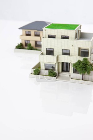 Photo for Small models of houses on white background, mortgage concept - Royalty Free Image