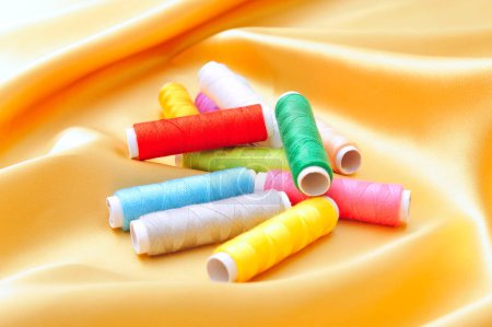 Photo for Colorful sewing threads  on silk  background, close up - Royalty Free Image