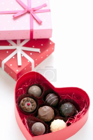 Photo for Heart-shaped box with chocolate candies, close up view - Royalty Free Image