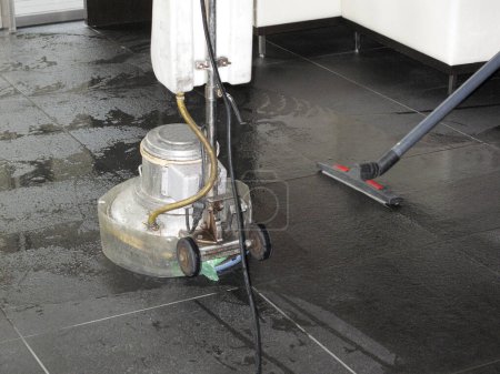 Photo for Cleaning floor tiles with water jet. - Royalty Free Image