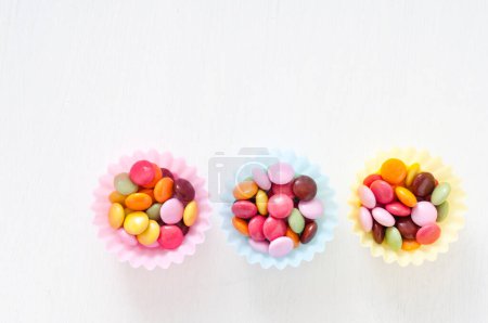 Photo for Colorful candies in bowls on  background, close up - Royalty Free Image