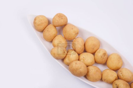 Photo for Plate of raw potatoes on white background - Royalty Free Image