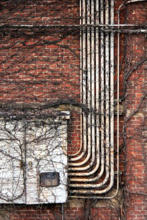 Photo for Old white tubes against red brickwall - Royalty Free Image