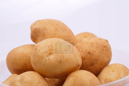 Photo for Bowl of raw potatoes on white background - Royalty Free Image