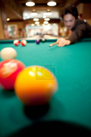 Photo for Asian man is playing billiard on background, close up - Royalty Free Image