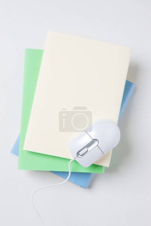 Photo for Computer  mouse and books on  background, close up - Royalty Free Image