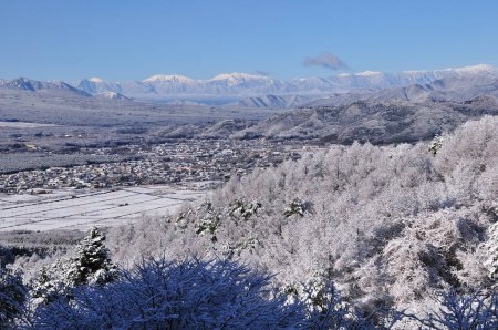 Photo for Winter landscape with snow covered trees, mountains and village in valley - Royalty Free Image