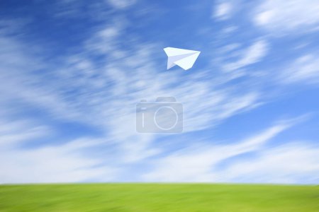 Téléchargez les photos : Avion volant en papier contre ciel nuageux - en image libre de droit