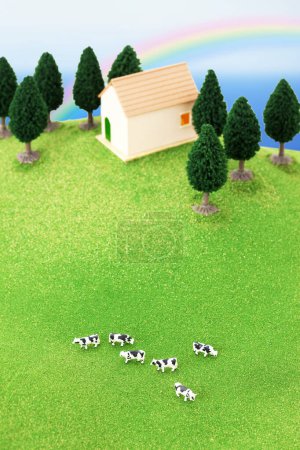 Photo for Modern house model with green grassy meadow and grazing cows - Royalty Free Image