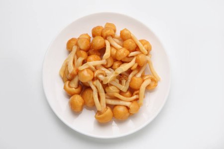 top view of nameko mushrooms on plate on white background