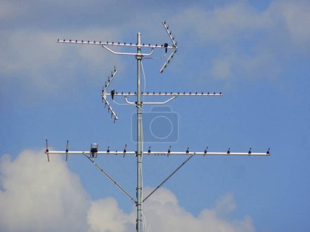 Téléchargez les photos : Antenne satellite sur le toit de la maison sur fond de ciel - en image libre de droit