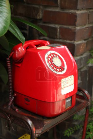 Photo for Old red dial telephone in retro interior - Royalty Free Image