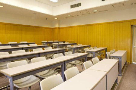 Photo for Interior of empty classroom in school. Rows of wooden desks and chairs - Royalty Free Image