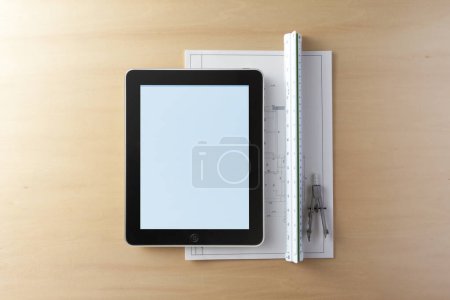 Photo for Top view of modern tablet device on wooden table background - Royalty Free Image