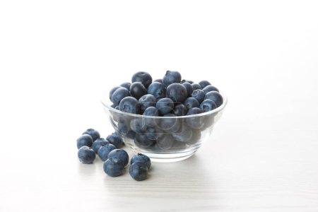 Photo for Blueberries in a white plate on a white background - Royalty Free Image