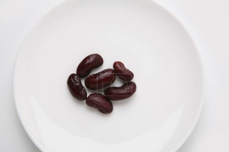 Photo for Black beans on a white plate - Royalty Free Image
