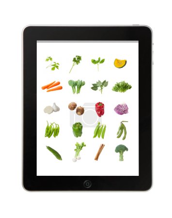 Photo for Close-up view of modern tablet device with vegetables - Royalty Free Image