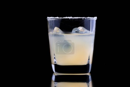 Photo for Glass of tequila with lime and ice on black background - Royalty Free Image