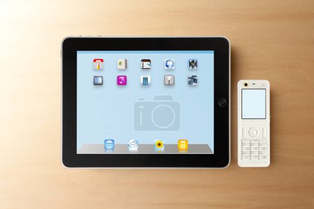 Photo for Top view of modern tablet device on wooden table background - Royalty Free Image