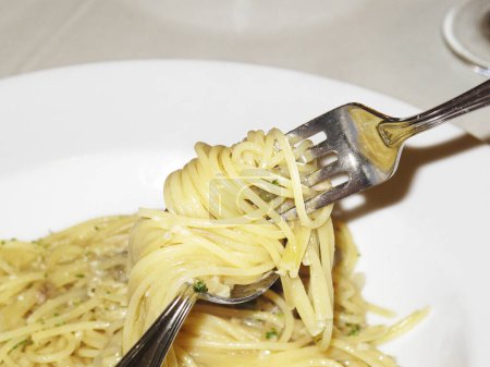 Photo for Italian  spaghetti with pesto sauce and fork on the table. - Royalty Free Image
