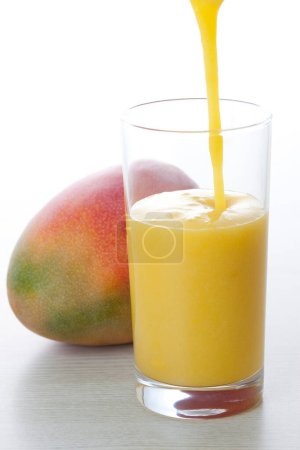 Photo for Glass of mango juice isolated on background - Royalty Free Image