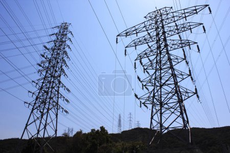 Photo for Low angle view of high voltage power lines against blue sky - Royalty Free Image