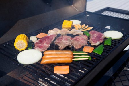 Photo for Close-up view of delicious steaks and vegetables cooking on grill - Royalty Free Image