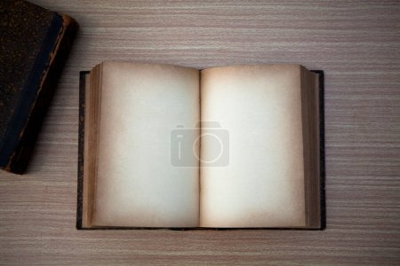 Photo for Old book on wooden table - Royalty Free Image