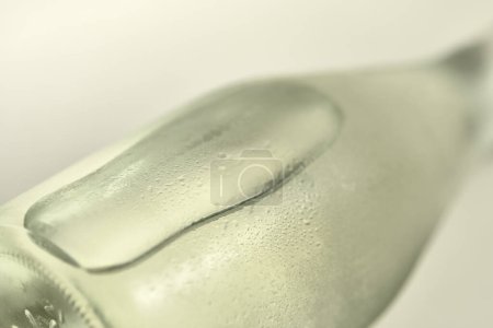 Photo for Close up of glass bottle of water on white surface - Royalty Free Image