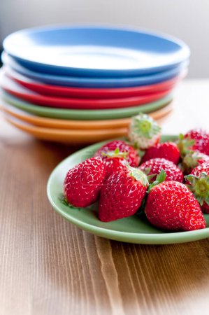 Téléchargez les photos : Assiette de fraises sur assiette et fond en bois. - en image libre de droit