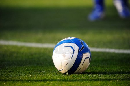 Téléchargez les photos : Jambes de sportifs en vêtements de sport jouant au football sur herbe - en image libre de droit