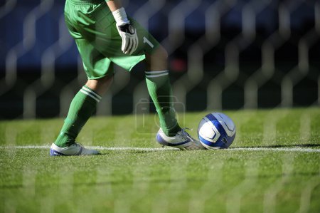 Photo for Legs of soccer player in sportswear playing with ball on grass - Royalty Free Image