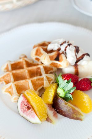 Photo for Close-up view of delicious belgian waffles with ice cream and fruits - Royalty Free Image
