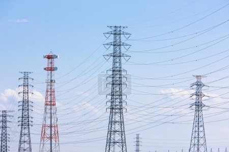Photo for High-voltage power lines over blue background, high voltage electric transmission towers - Royalty Free Image