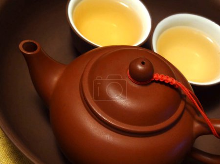Photo for A teapot and two cups of tea on a plate - Royalty Free Image
