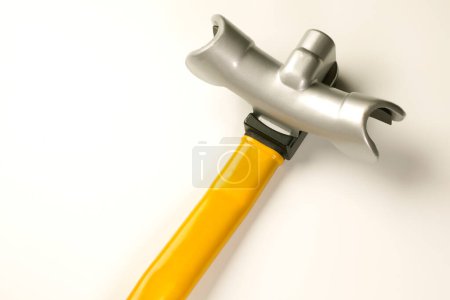 Photo for A hammer with a yellow handle on a white surface - Royalty Free Image