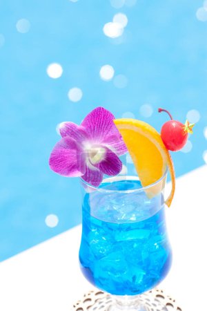 Photo for Close-up view of glass with cocktail near swimming pool - Royalty Free Image