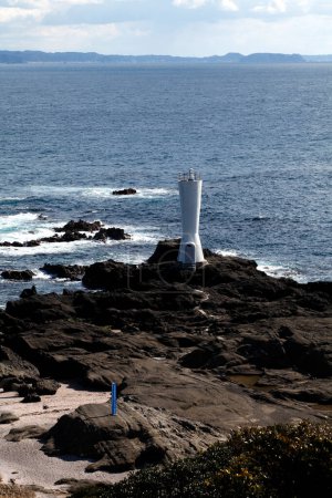 Photo for View of lighthouse on rocky coast - Royalty Free Image