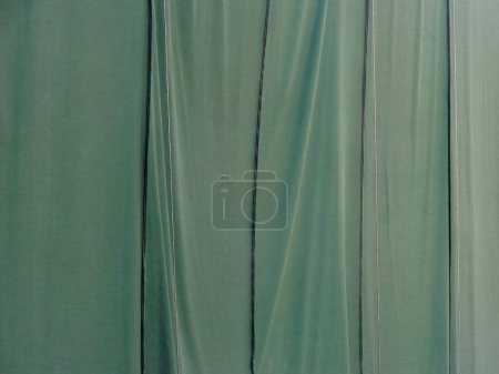 Photo for Green curtain with shadow on background, close up - Royalty Free Image