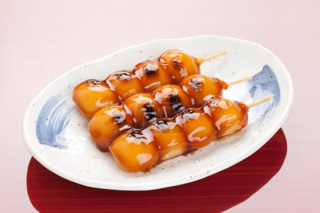 Dumplings with Salty-sweet Sauce, Mitarashi Dango, traditional Japanese rice flour dumplings, skewered onto sticks 