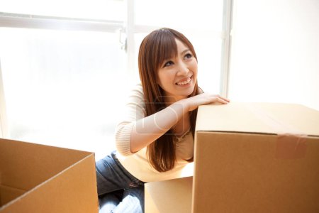 Photo for Young woman moving in new home. - Royalty Free Image