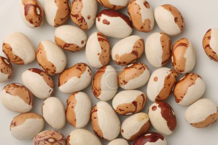 Photo for Top view of organic brown beans on white surface - Royalty Free Image