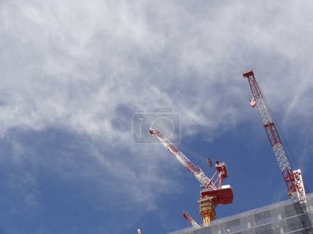 Photo for Construction cranes and building under blue sky background - Royalty Free Image