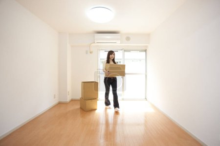 Photo for Asian woman with boxes at home - Royalty Free Image