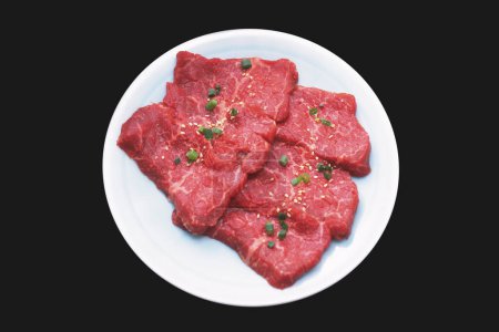 Photo for Close-up view of fresh meat slices with herbs and spices on plate - Royalty Free Image