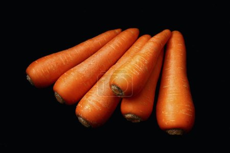 Photo for Fresh organic carrots on black background - Royalty Free Image