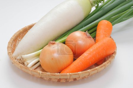 Photo for Basket of vegetables including carrots, onions, and chinese turnip - Royalty Free Image
